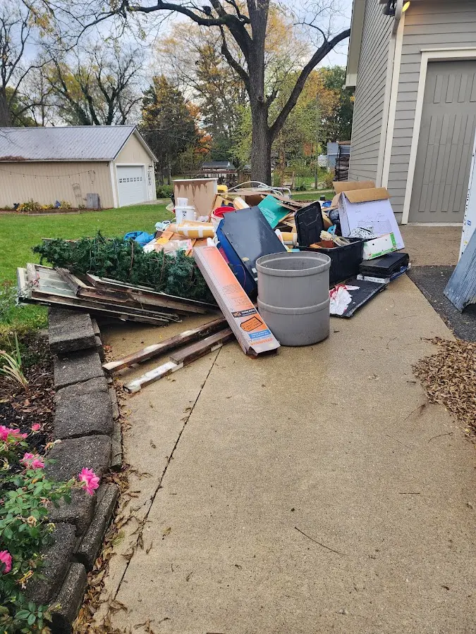 Dumpster being loaded with debris for Demolition Dumpster Rental in Muncie